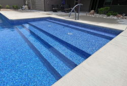Vinyl steps with sun ledge bubblers create an inviting entry into this pool